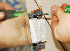 Installing GFCI outlets in place of a single pair that were not GFCI. Located direclty above the sink, the old outlet was a code violation.